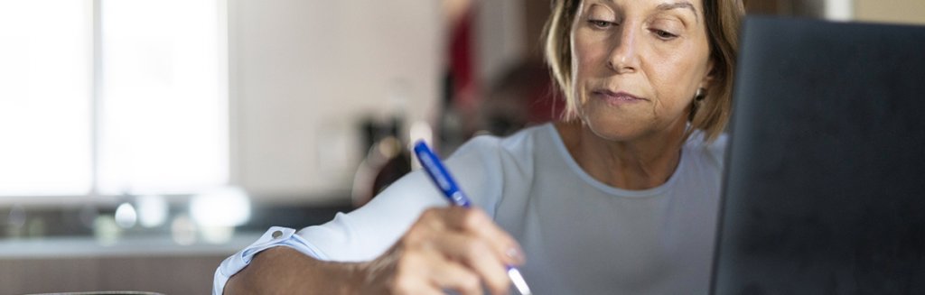 Mulher segurando caneta de forma concentrada